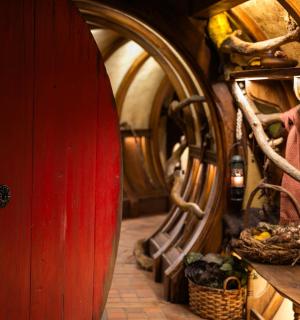 a red surfboard is in a room with barrels