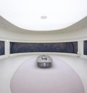 a large white room with a bench in the middle of it