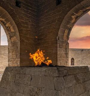 a fire pit in front of a castle