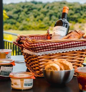 a basket of bread and a bottle of wine on a table