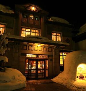 a building with an igloo in the snow at night