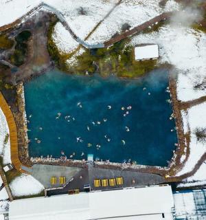 an aerial view of a swimming pool in the snow