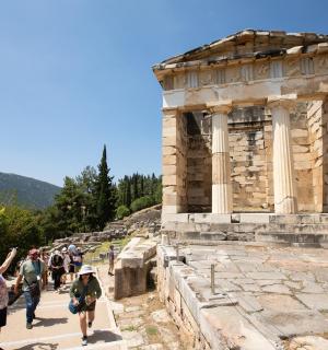 a group of people walking around the ruins