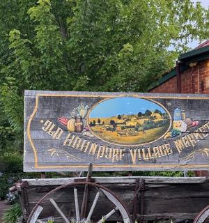 a sign for a barnoperative village way in front of a building