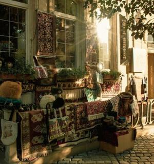 一只泰迪熊坐在一栋建筑前的沙发上