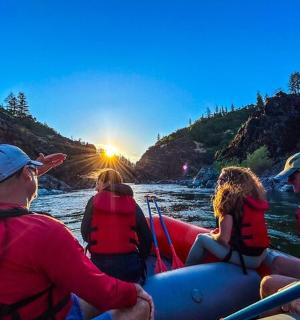 a group of people on a raft on a river