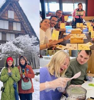 a group of people standing around a table with food