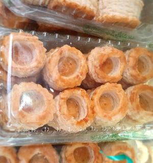 a plastic container filled with donuts and bread
