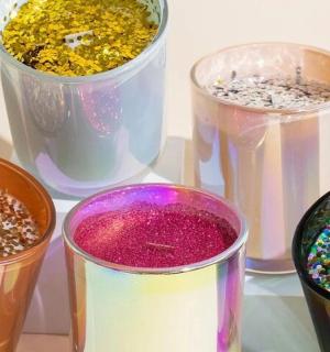 a group of four different colored glasses with sprinkles
