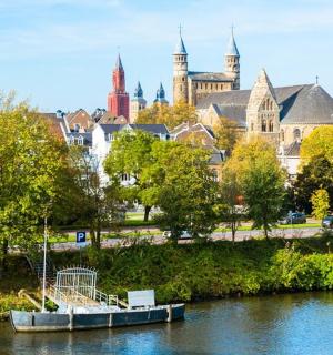 a boat on a river in front of a city