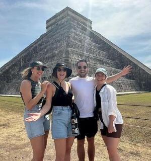 a group of people standing in front of a pyramid
