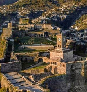 an old building with a clock tower on a hill