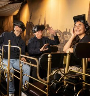 a group of three people wearing virtual reality hats