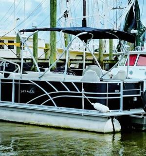 a black and white boat parked in the water