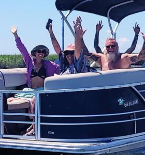 a group of people in a boat on the water