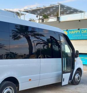 a white van parked in front of a building with palm trees