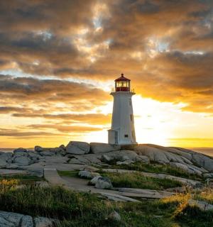 a lighthouse sitting on top of a rocky island