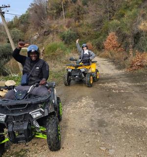 two people on atvs on a dirt road