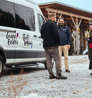 a group of people standing next to a van