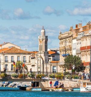 a bridge over a river in front of buildings