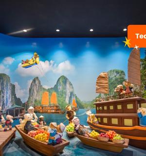 a mural of a group of people on boats in the water