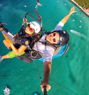 two people on a rock wall in the water