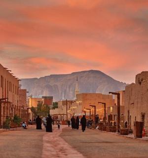 a street in an old town with a mountain in the background