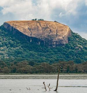 a large rock in the middle of a body of water