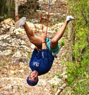 a person on a rope swing in the woods