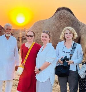 a group of people standing in front of an elephant