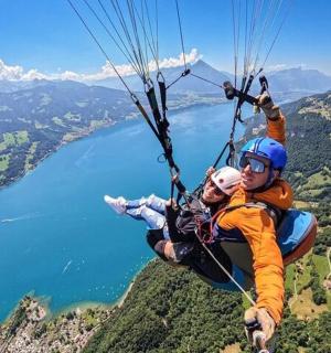 a man and a child hanging from a parachute