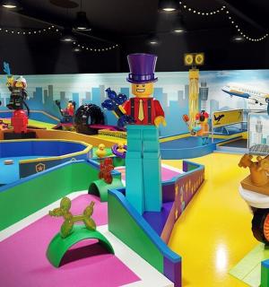 a play room with lego duplos and a toy dealership