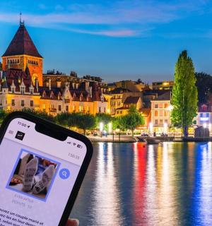 a person holding a cell phone in front of a river