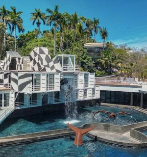 a large house with a swimming pool and a fountain
