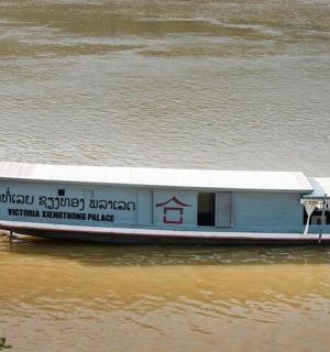 a ferry boat on a river in the water