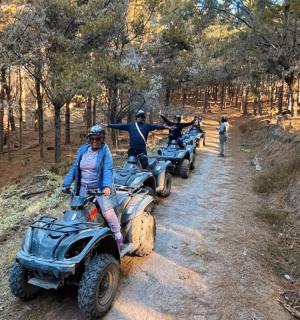 a group of people riding on atvs on a dirt road