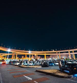 a parking lot with cars parked in front of a building