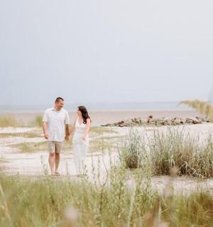 a man and a woman walking on the beach