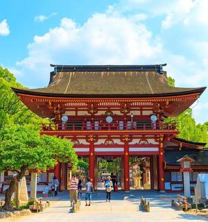 et asiatisk tempel med folk, der går foran det