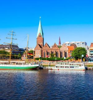 two boats docked in the water in front of a city