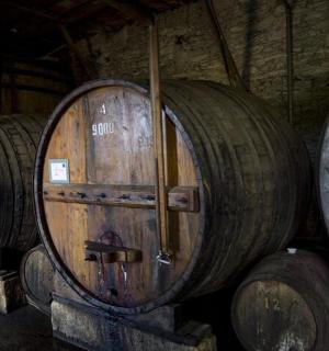 three wooden wine barrels stacked in a room