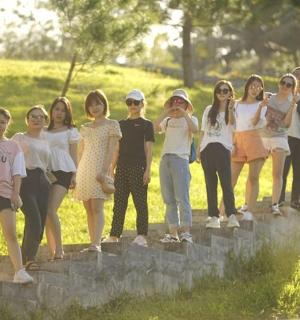 a group of young people standing on a stone wall