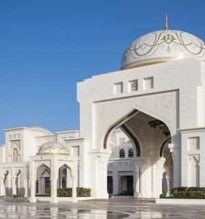 a white mosque with two domes on top of it