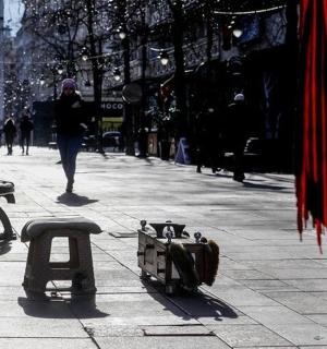 a person walking down a city street with a person walking