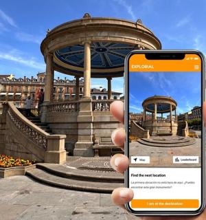 a person holding up a cell phone in front of a building