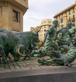a statue of a group of bulls laying on the ground