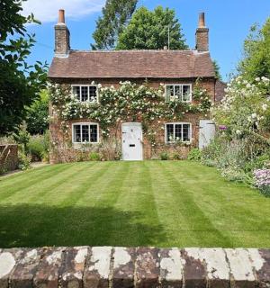 an old brick house with a large yard
