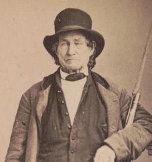 an old photo of a man wearing a hat