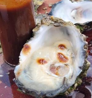 桌上的饮料旁边有一只牡蛎