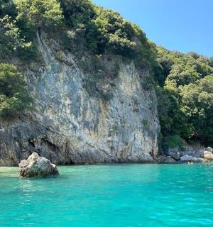 a boat in the water next to a mountain